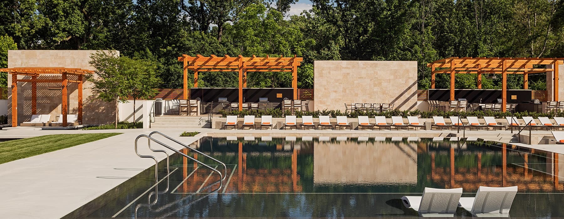 view of pool showing ample reclining-style seating and surrounding lush landscaping