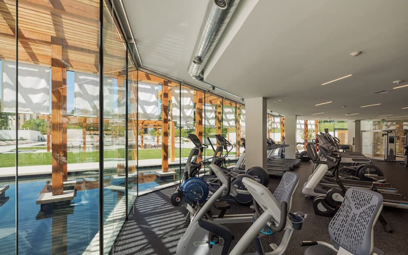 fitness room with treadmills in front of large windows with expansive views