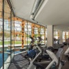 fitness center with rows of treadmills and large window views