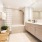 bathroom with a large mirror and ample lighting