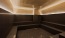 large sauna room with interior lighting and seating